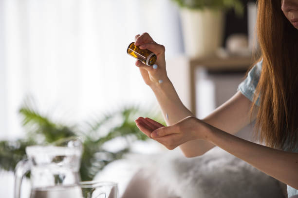 istock Woman pouring medicine into hand 1227520312