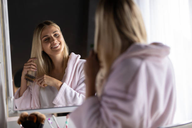istock Woman brushing hair 1227521625