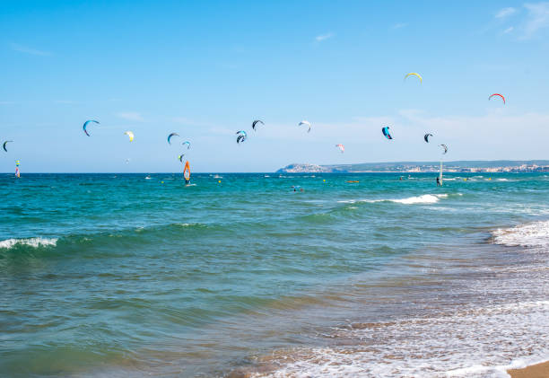 istock Beach full of colourful kite surfers 1227522087