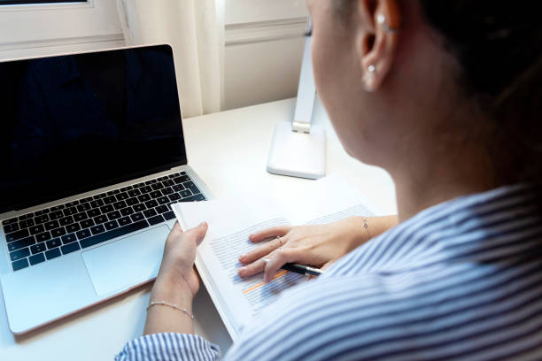 istock Young attractive female doing homework sitting desktop with modern laptop computer 1227522244