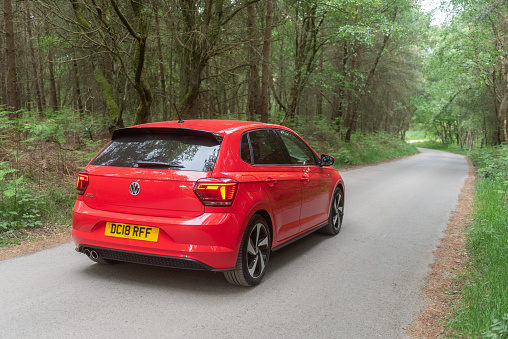 Staffordshire, England, UK - 26th May 2020:  A MK6 Volkswagen Polo GTI Plus in Flash Red, stopped on country road in Cannock Chase, Staffordshire, England, UK. The VW Polo is now in it's sixth generation.