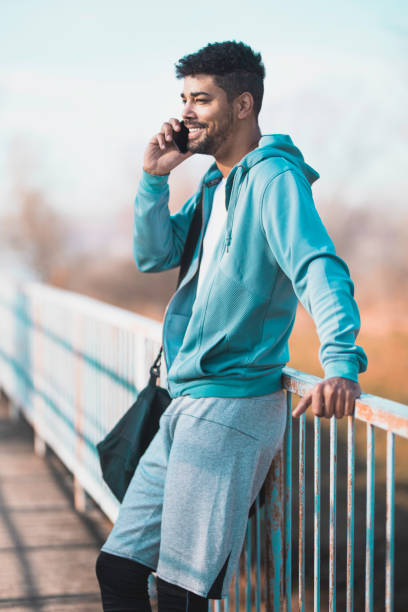 istock Young athlete using his phone and enjoying in nature 1227524355