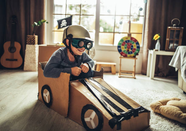 istock Father and son playing car racing with cardboard boxes 1227525182