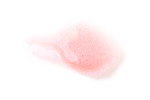 Transparent fluid lips gloss sample, isolated on white background. Transparent fluid lips gloss sample, isolated on white background. Smudged lipgloss with glitters pale pink lipstick stock pictures, royalty-free photos & images