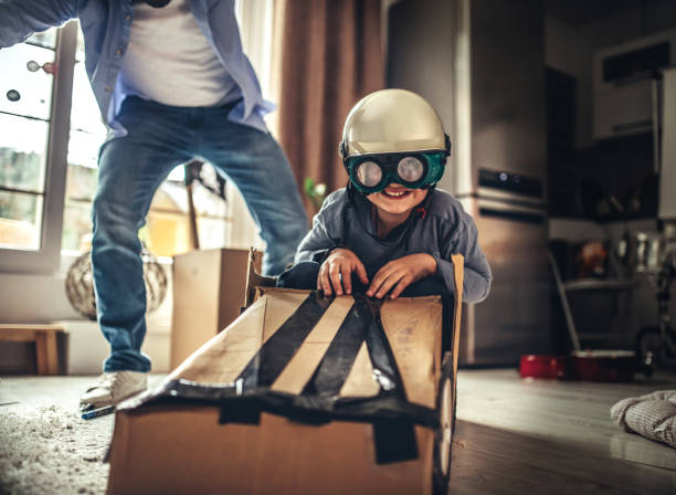 istock Father and son playing car racing with cardboard boxes 1227525461