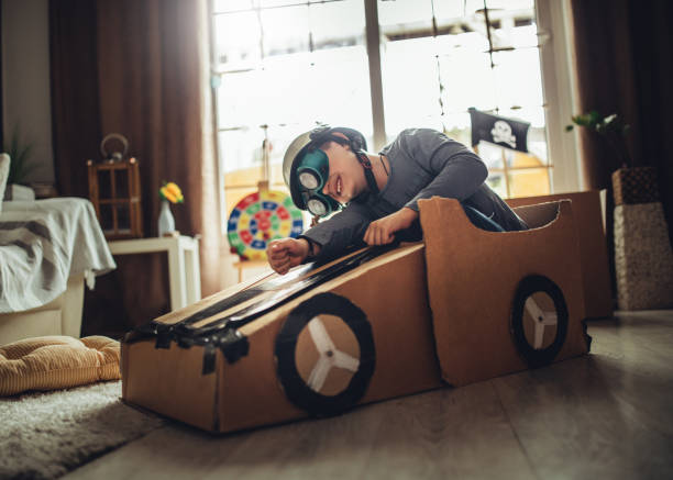 istock Father and son playing car racing with cardboard boxes 1227525469