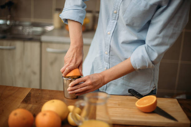 istock Young woman cutting orange 1227525479