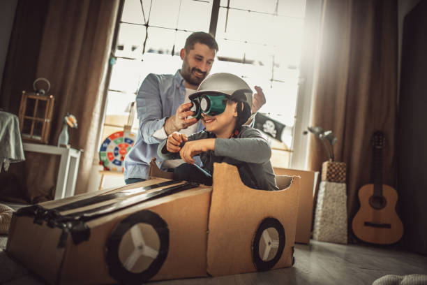 istock Father and son playing car racing with cardboard boxes 1227525516