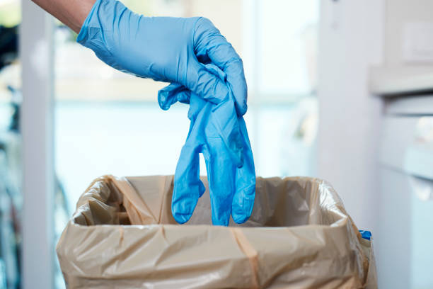istock man throwing latex gloves to the trash can 1227528597