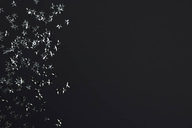 istock Silver stars confetti on a black background. 1227532926