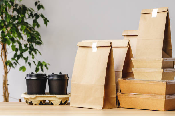 Many various take-out food containers, pizza box, coffee cups and paper bags on light grey background Many various take-out food containers, pizza box, coffee cups and paper bags on light grey background. Food delivery bag lunch stock pictures, royalty-free photos & images