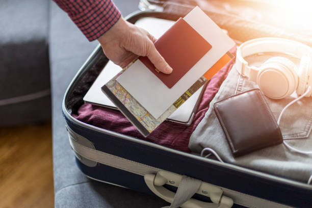 istock Man putting things things for the road in his suitcase 1227535325
