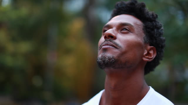 Black man looking at the sky outdoors