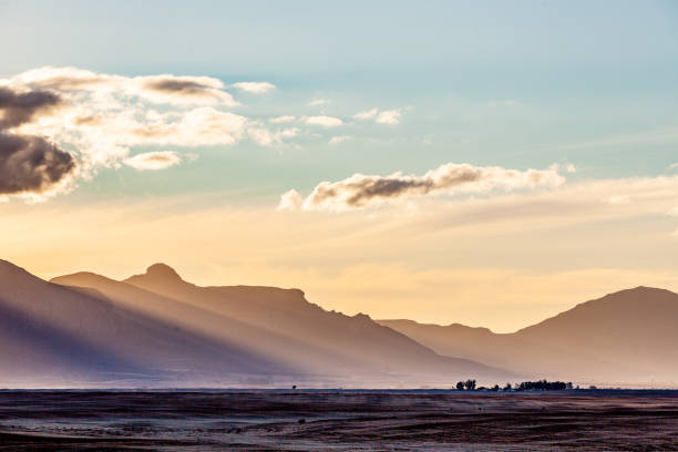 istock Rays of sunlight shine on a mountain range at dusk 1227538239