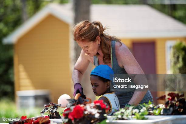 Woman Gardening With Her Son Stock Photo - Download Image Now - Domestic Life, Gardening, 4-5 Years
