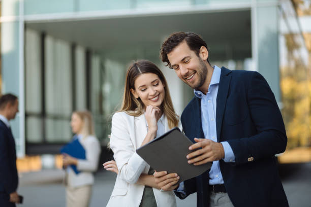 istock Business couple working online outdoors on a tablet computer 1227539551