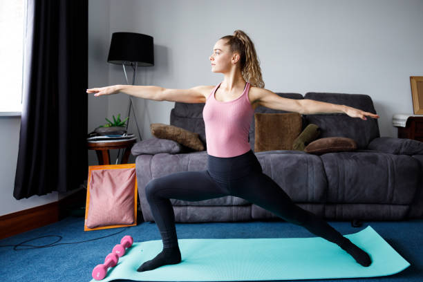 istock Young girl doing indoor exercise workout at home 1227539768