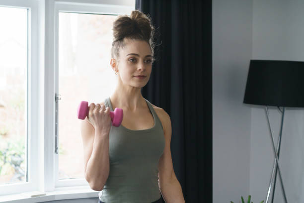 istock Young girl doing indoor exercise workout at home 1227539962