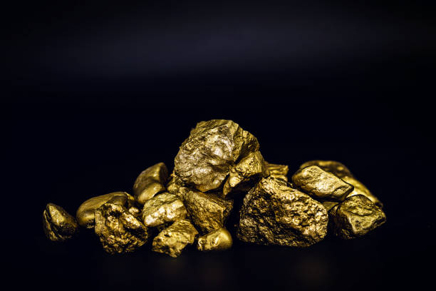 istock Golden nuggets isolated on black background. Luxury concept. 1227539992