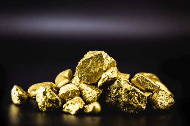 istock Golden nuggets isolated on black background. Luxury concept. 1227540014