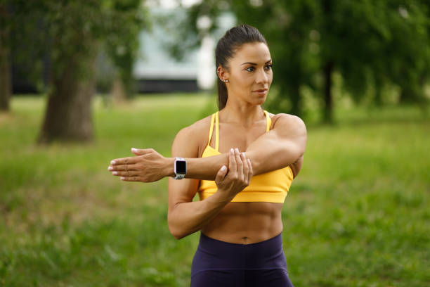 istock A young sports woman stretching before jogging in the park 1227540310
