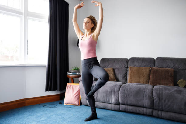 istock Young girl doing indoor exercise workout at home 1227540351