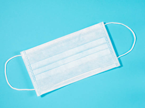 istock Face mask for protection against viruses on blue background 1227543046