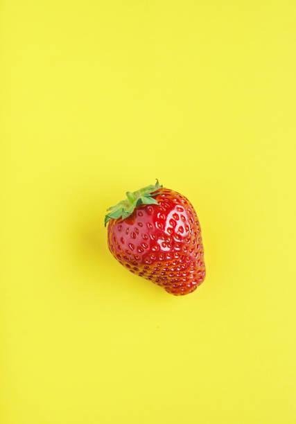 istock Juicy strawberries on yellow background. 1227543788