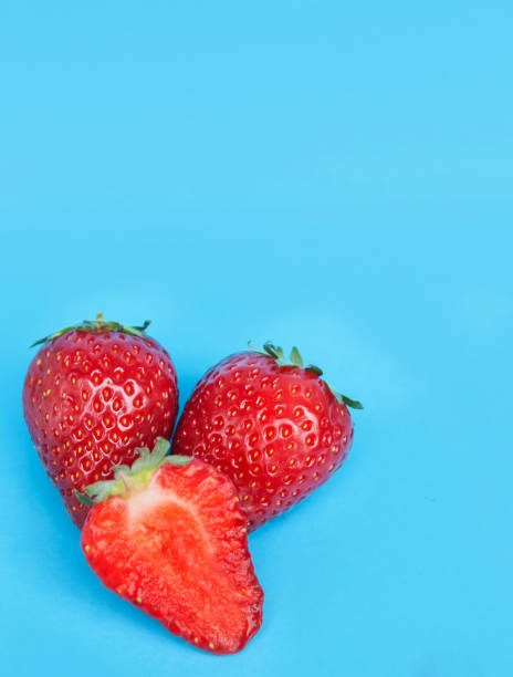 istock Juicy strawberries on blue background. 1227543847