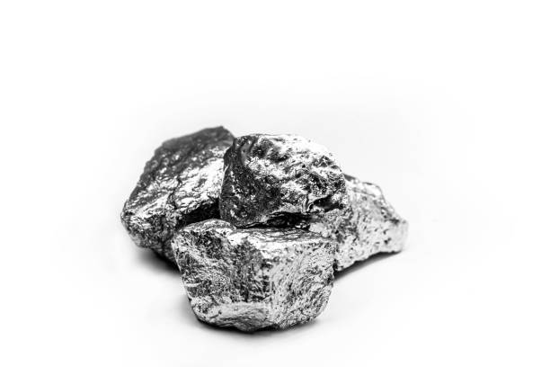 big big silver nugget on black background. Raw silver stone, silver nugget native to Liberia, isolated on black background. Mineral extraction. Manganese, manganese, or magnesium stone is a chemical element, it is in the manufacture of metal alloys. Silver colored ore, industrial use. Ore on black isolated background. precious metals stock pictures, royalty-free photos & images