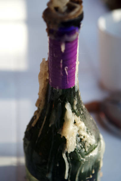 candle flowing out of wine bottle