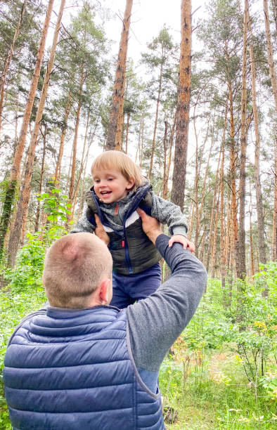 istock A fair-skinned man is circling a cheerful little child. 1227544625