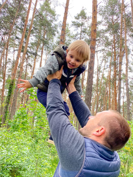 istock A fair-skinned man is circling a cheerful little child. 1227544723