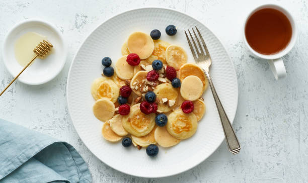istock Tiny pancakes, small thin funny crumpet, children's food. 1227544771