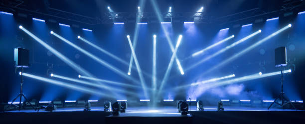 Stage for live concert Online transmission. Business concept for a concert online production broadcast in realtime as events happen. Stage for online live concert Concert live streams available online Online event entertainment concept. Background for online concert. Blue stage spotlights. Empty stage with blue spotlights. Blue stage lights. Online COVID-19 concert. Live streaming concert cancellation photos stock pictures, royalty-free photos & images