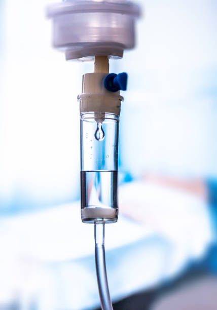 istock Dripping medical perfusion close up equipment in clinic background. Saline Solution IV Drip Fluid for Infusion in Hospital. Intravenous infusion tube equipment in hospital. antiviral treatment 1227547139