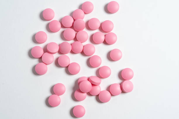 istock pink pills isolated on white background 1227548251
