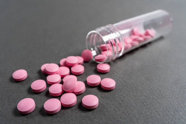 istock Pink medicine pills on a grey background 1227548509