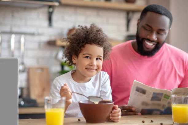 istock Dark-haired african american father having a nice morning with his kid 1227548637