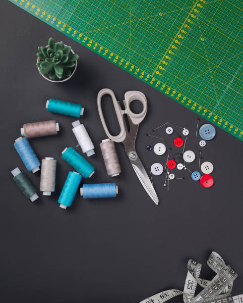 istock sewing items on a black background from above 1227549927