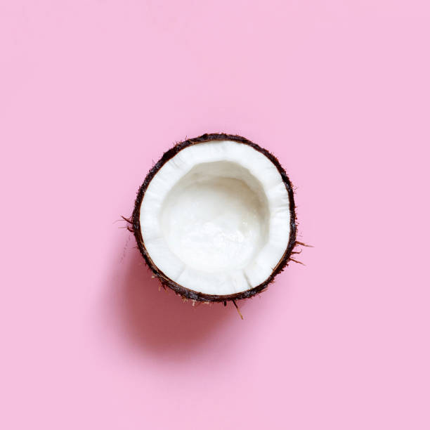 istock Coconut piece on a light pink background 1227550374