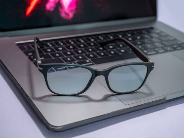 istock Blue light blocking glasses on the laptop. Black frame glasses for filtering blue light from the computer. Prevent Computer Vision Syndrome. Eye protection from PC screen 1227551320