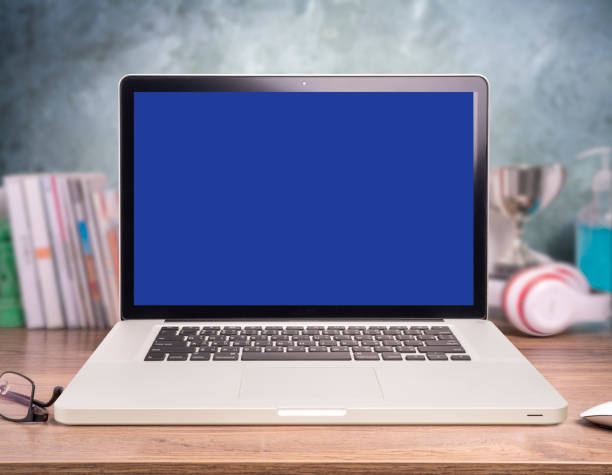 istock Laptop or notebook with blank screen on wood table in blurry background 1227552004