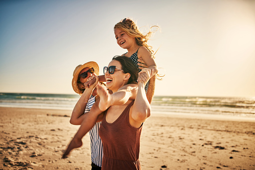 Outdoor, father carrying child and smile with family, adventure and happiness with love, cheerful and support. Face, dad with kid on the shoulders and care in a park, play or relax with joy or nature