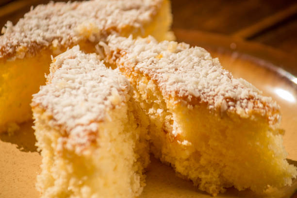 istock Coconut cake sliced in brown dish on wooden table. Focus seletive 1227552889