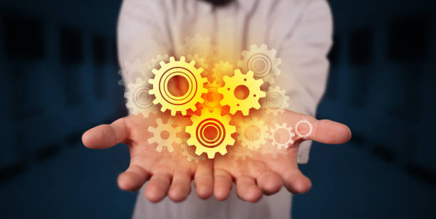 istock Hand holding gears in his hand 1227553497