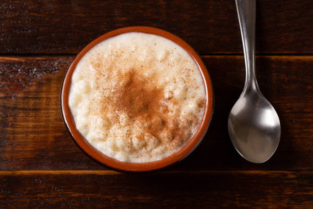 istock Coconut cake sliced in brown dish on wooden table. Focus seletive 1227553561
