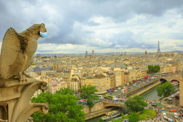istock Statue of gargoyle with surgical mask 1227554085