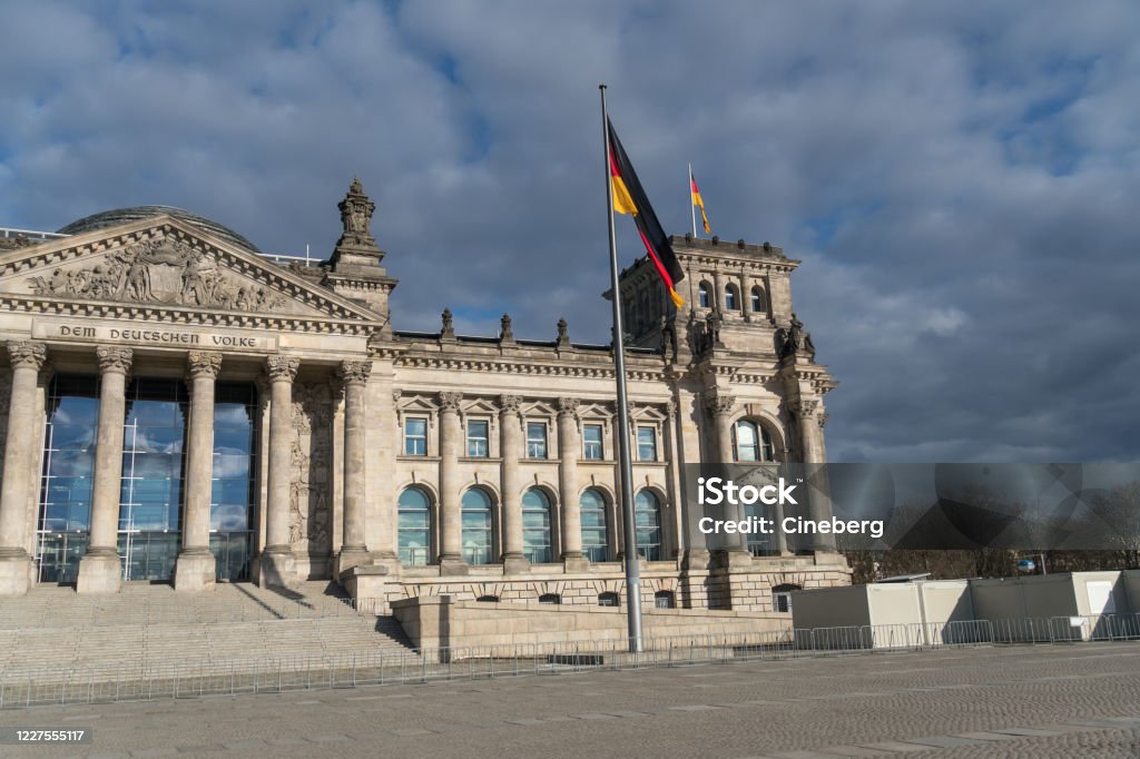 Berlin Reichstag Facade of the Berlin Reichstag building seen from Platz der Republik, the former Königsplatz, during the city's lockdown due to the COVID-19 spreading Architectural Column Stock Photo