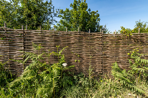 Woven willow hurdle fence, a natural way to make a boundary.
